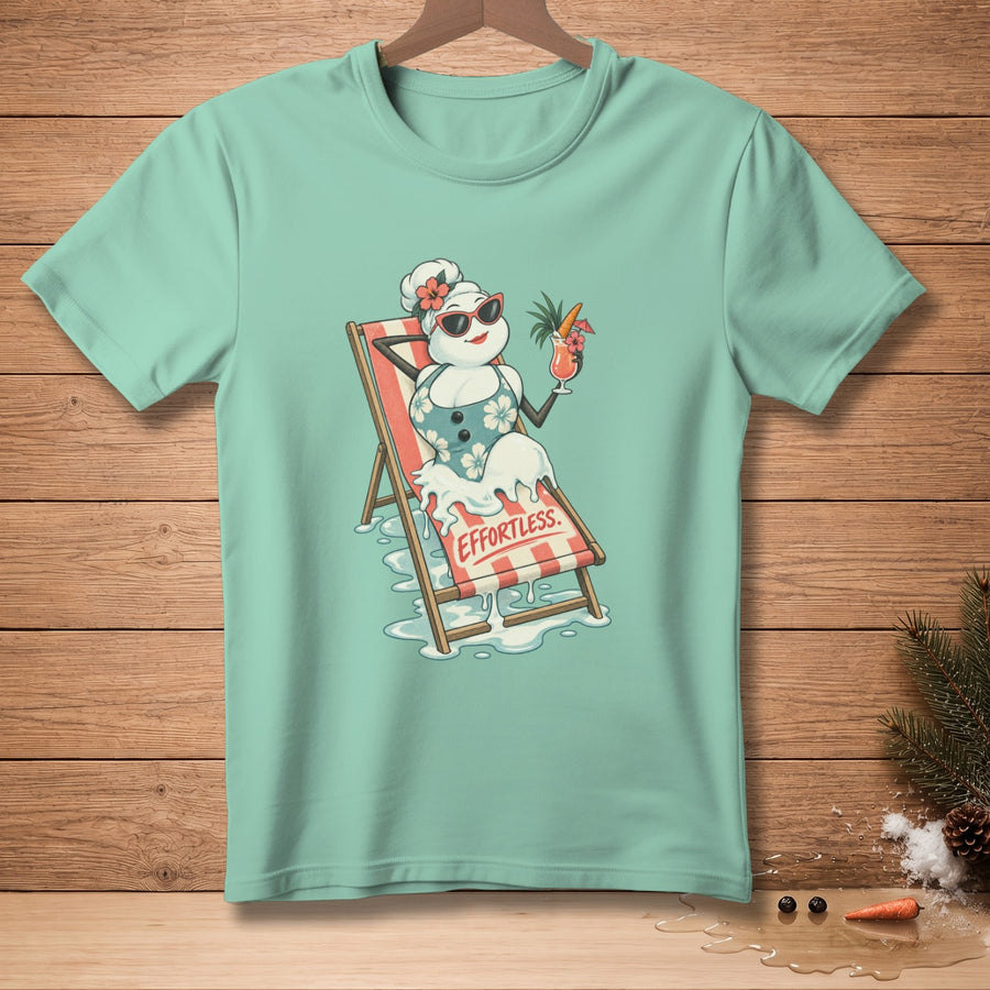 Snowman in swimsuit relaxing on lounge chair with cocktail, text "EFFORTLESS".