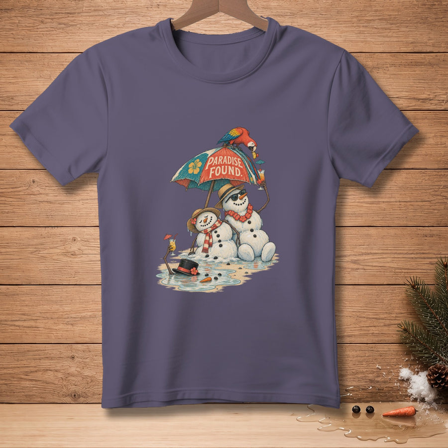 Two snowmen relax under a beach umbrella with a parrot and cocktails, text says "Paradise Found".