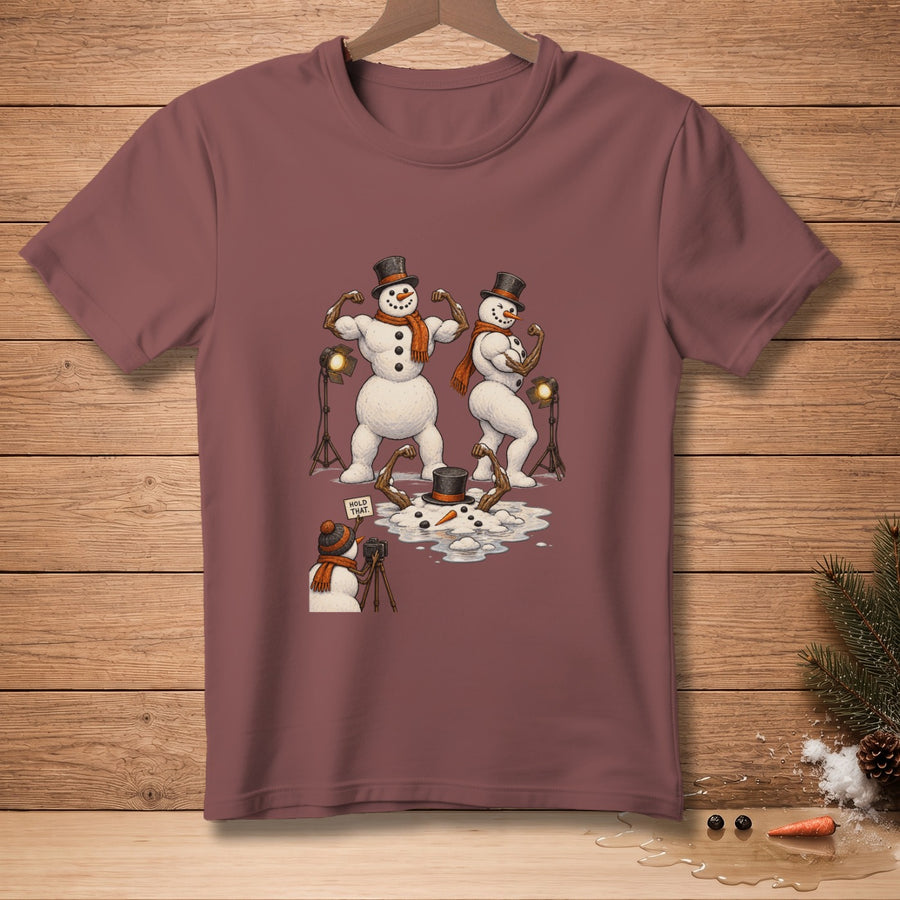 Two buff snowmen pose for a photographer snowman with a "Hold That" sign.