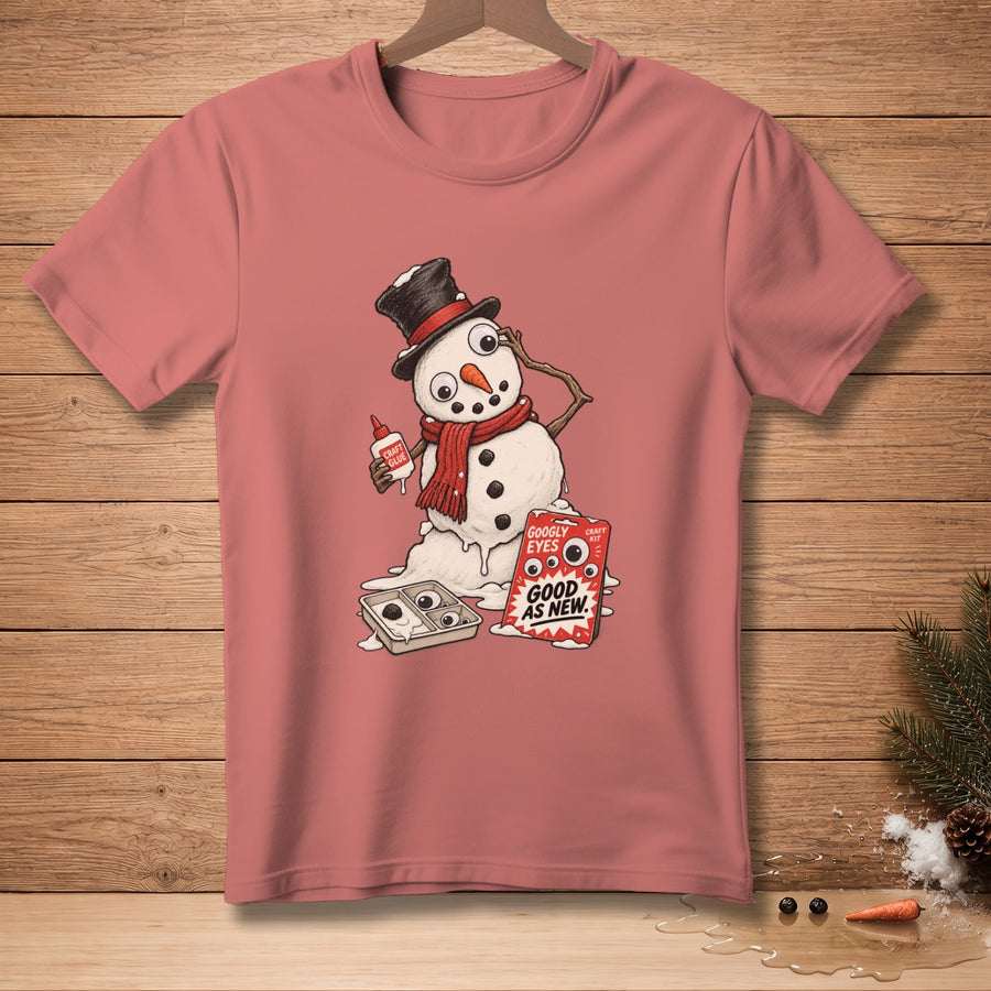 T-shirt with melting snowman holding glue and a craft kit labeled "Googly Eyes Good As New".