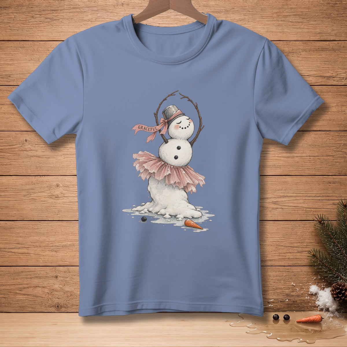 Light blue t-shirt with a drawing of a melting snowman ballet dancer with "GRACEFUL" ribbon.