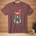 T-shirt with a flamingo float holding a melting snowman on an escalator.