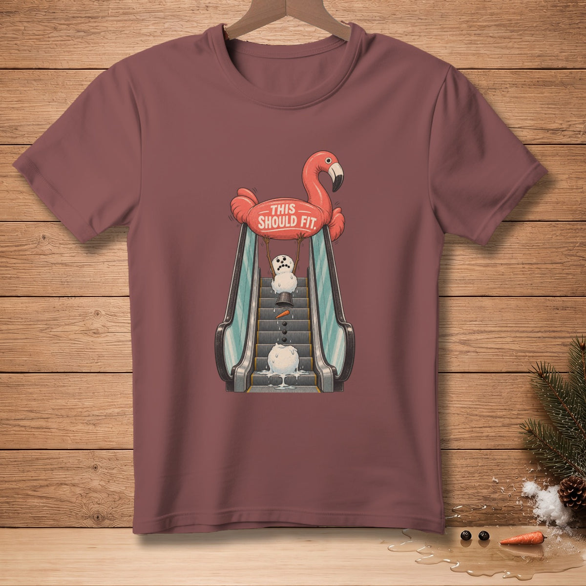 T-shirt with a flamingo float holding a melting snowman on an escalator.
