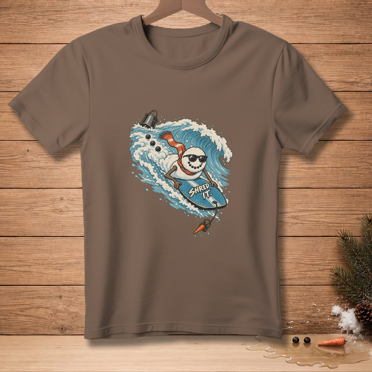 Snowman surfing a wave on a surfboard with text "Shred It."