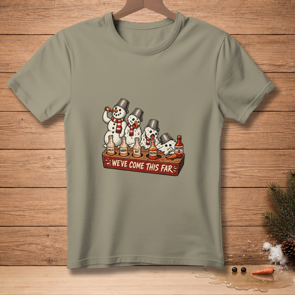 Snowmen tasting hot sauce labeled mild, warm, hot, brutal, and absurd. We've Come This Far.