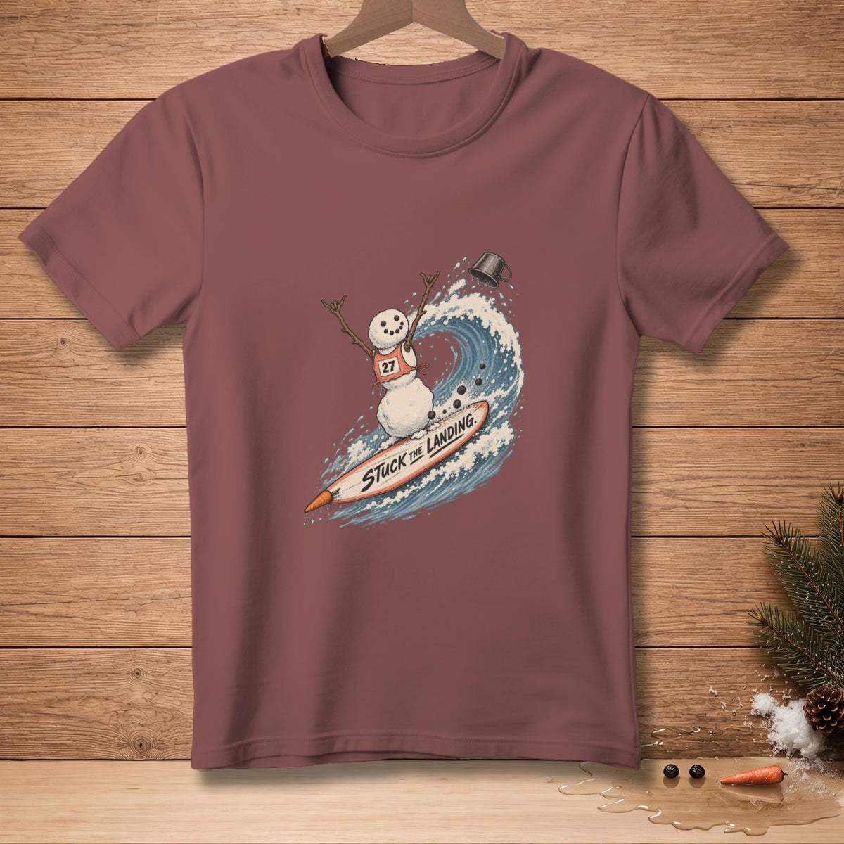 Snowman surfing a wave on a surfboard with text "Stuck The Landing".