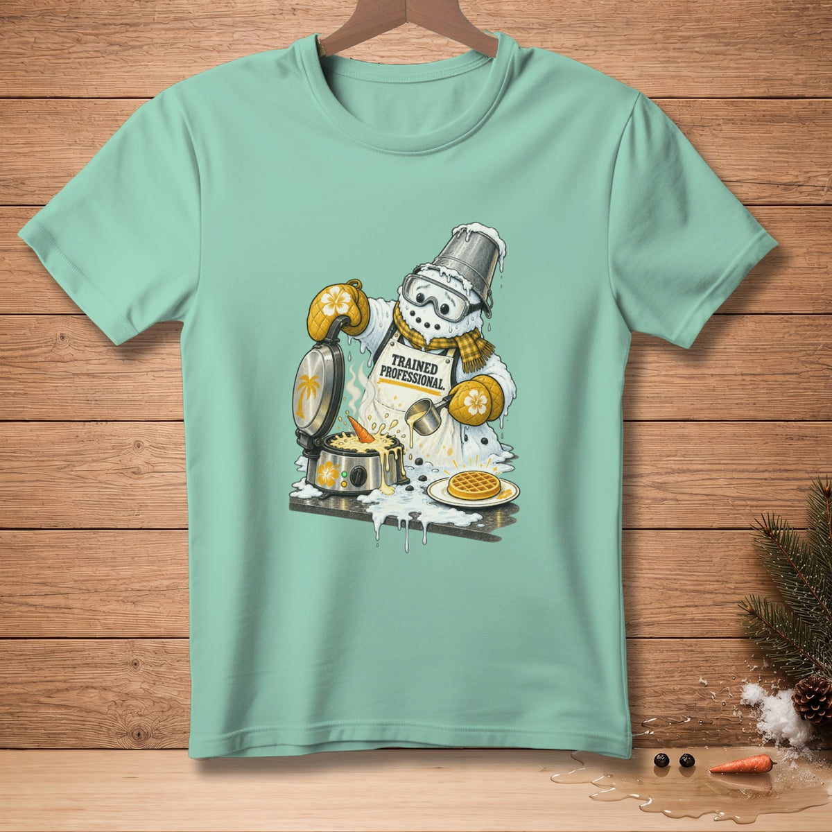 Snowman making waffles with a bucket on its head, wearing an apron that says "Trained Professional".