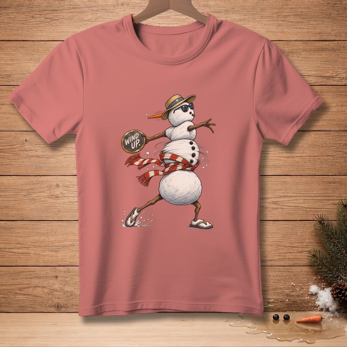 T-shirt with a snowman wearing a hat, sunglasses, and scarf, holding a sign that says "Wind Up."