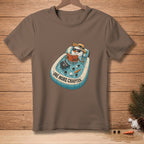 T-shirt with a snowman relaxing in a pool reading a book, text "One More Chapter".