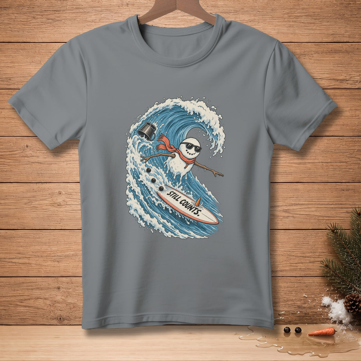 Snowman surfing a wave on a surfboard with "STILL COUNTS." text.