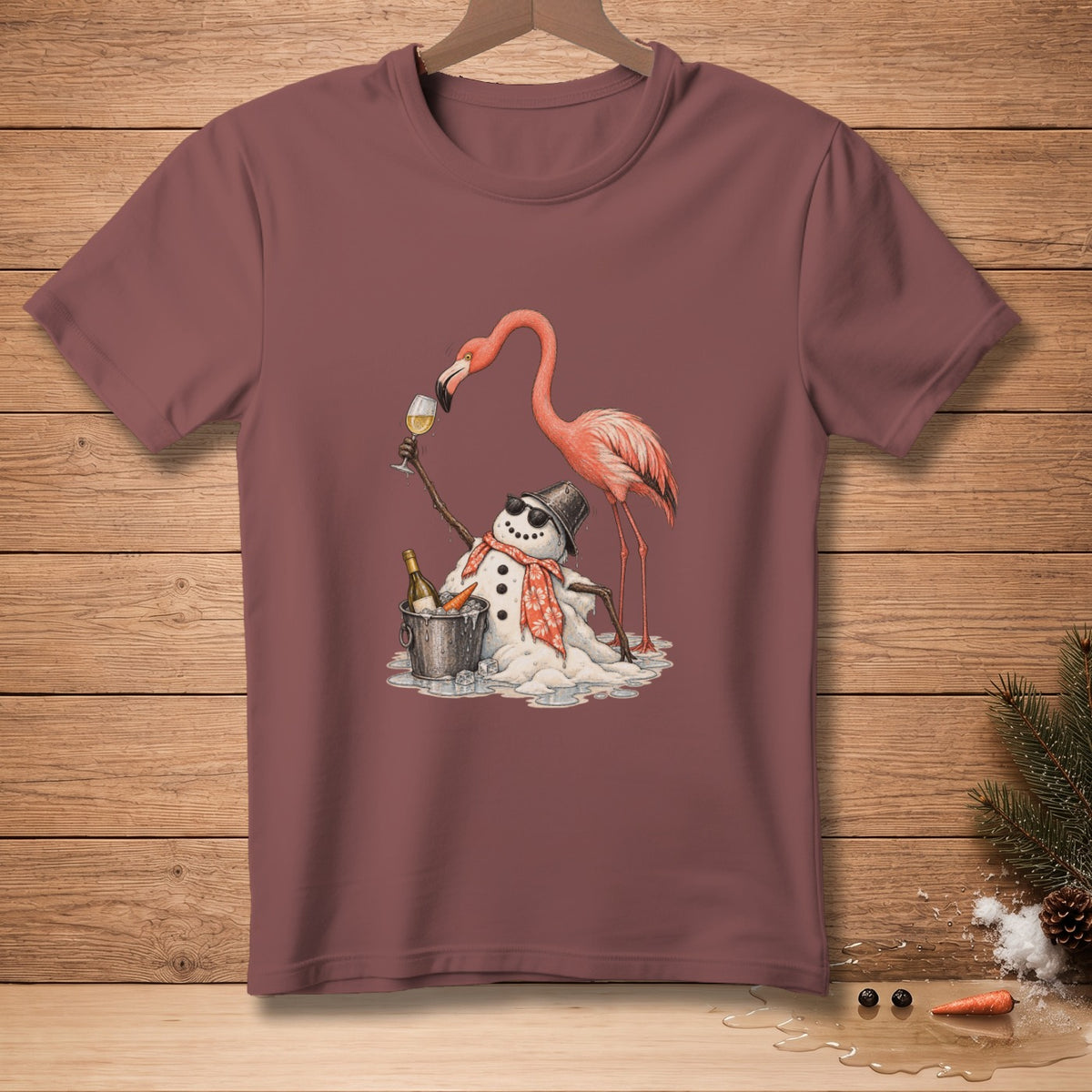 Flamingo and melting snowman with sunglasses, scarf, and drinks on a maroon t-shirt.