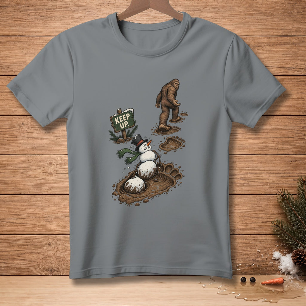 Bigfoot walks past a snowman stuck in mud next to a "KEEP UP" sign.
