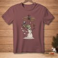 Snowman with spinning fan, bucket, and carrot on maroon t-shirt.