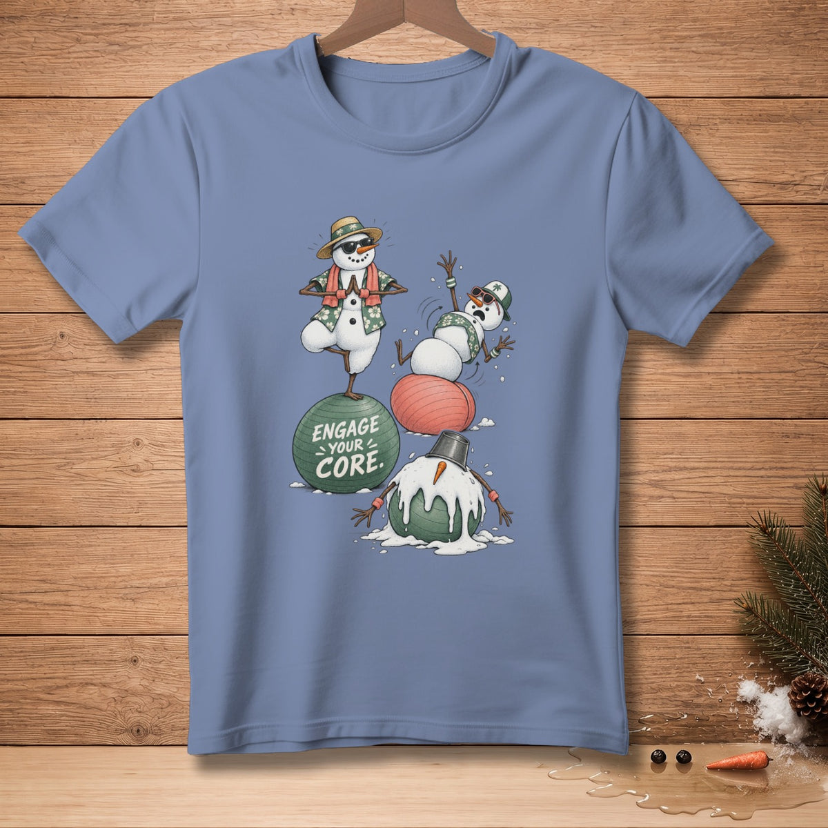 T-shirt graphic of snowmen exercising on fitness balls with text "Engage Your Core".