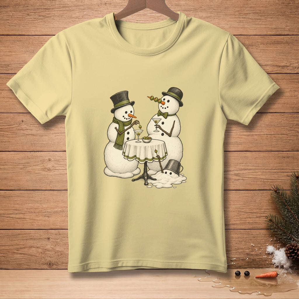 Two snowmen in hats and scarves toast with martinis at a table.