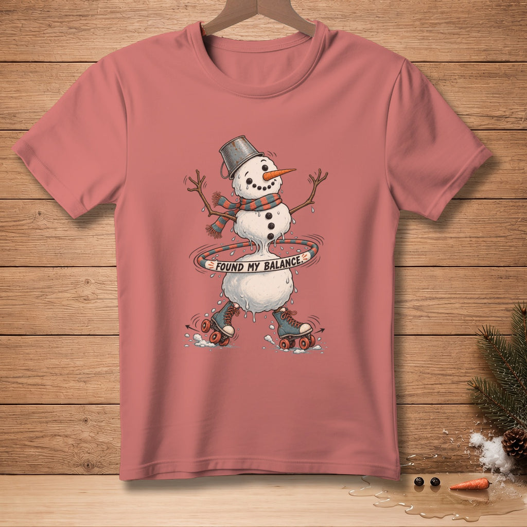 Snowman in roller skates hula-hooping with text "FOUND MY BALANCE" on a t-shirt.
