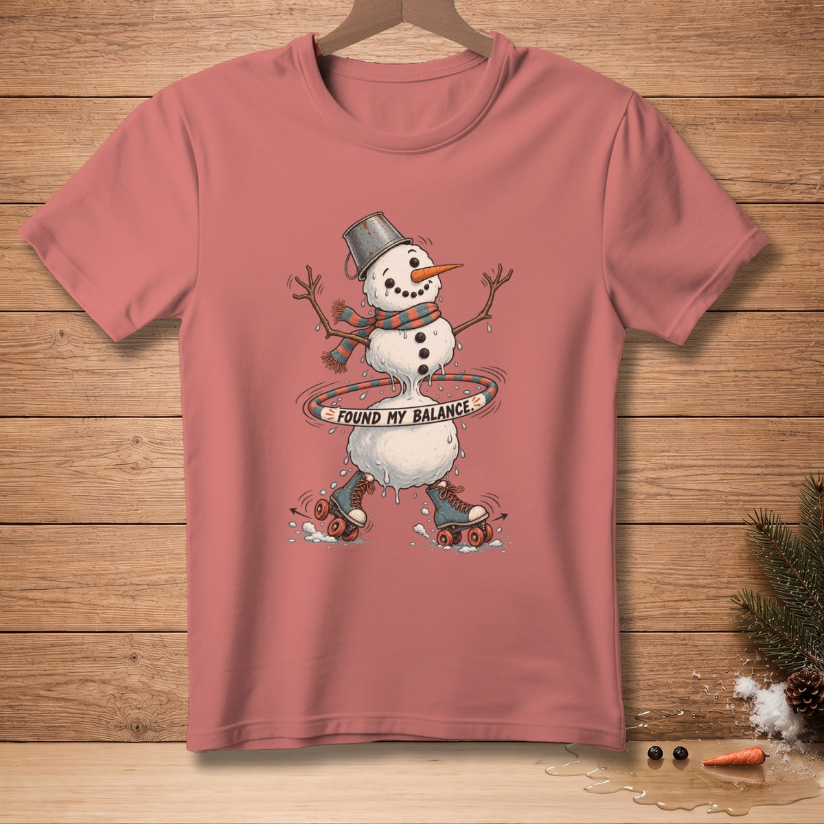 Snowman in roller skates hula-hooping with text "FOUND MY BALANCE" on a t-shirt.