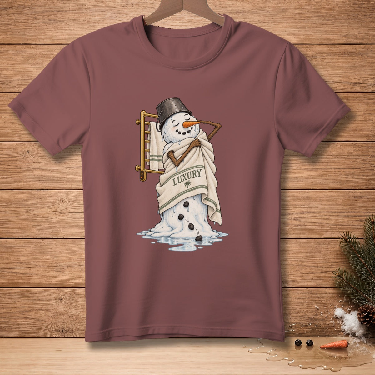 Melting snowman wrapped in towel with "Luxury" text on a maroon t-shirt.