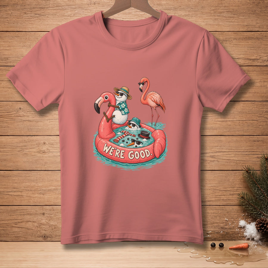 T-shirt with snowmen and flamingo floating in pool with "WE'RE GOOD" text.