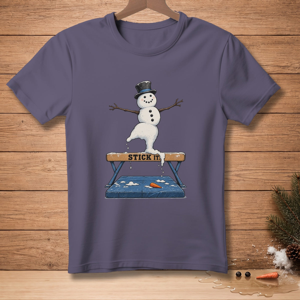 Snowman with a top hat balances on a gymnastics beam with text "STICK IT".