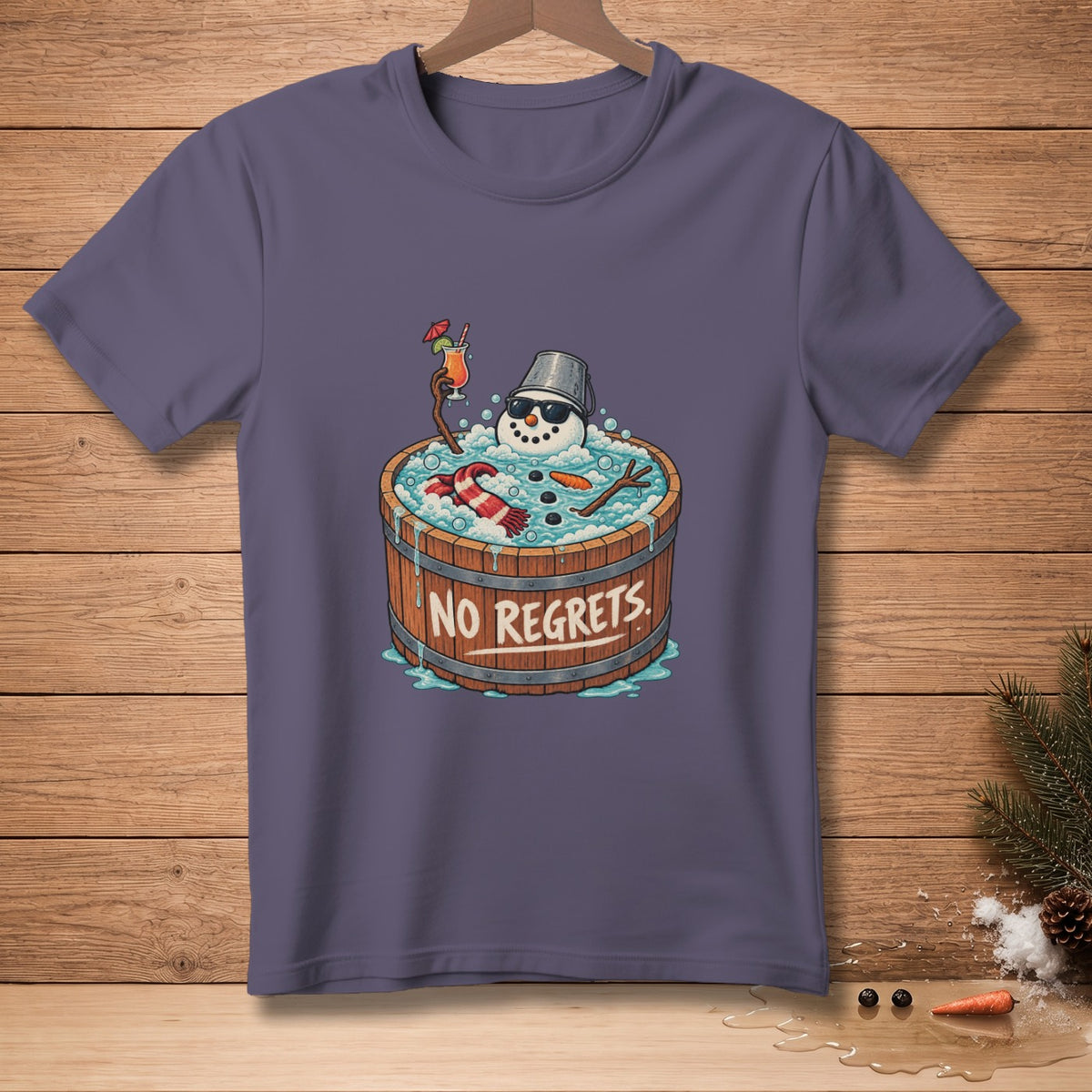 T-shirt graphic of a snowman in a wooden tub with a drink and text "NO REGRETS".
