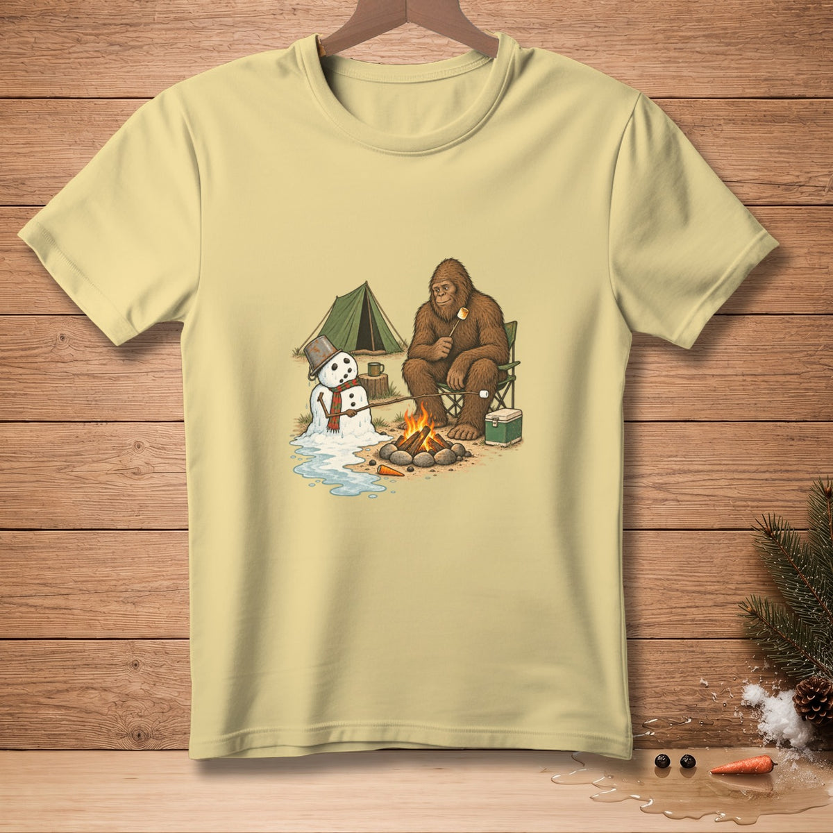 Bigfoot and melting snowman by campfire with tent and cooler.