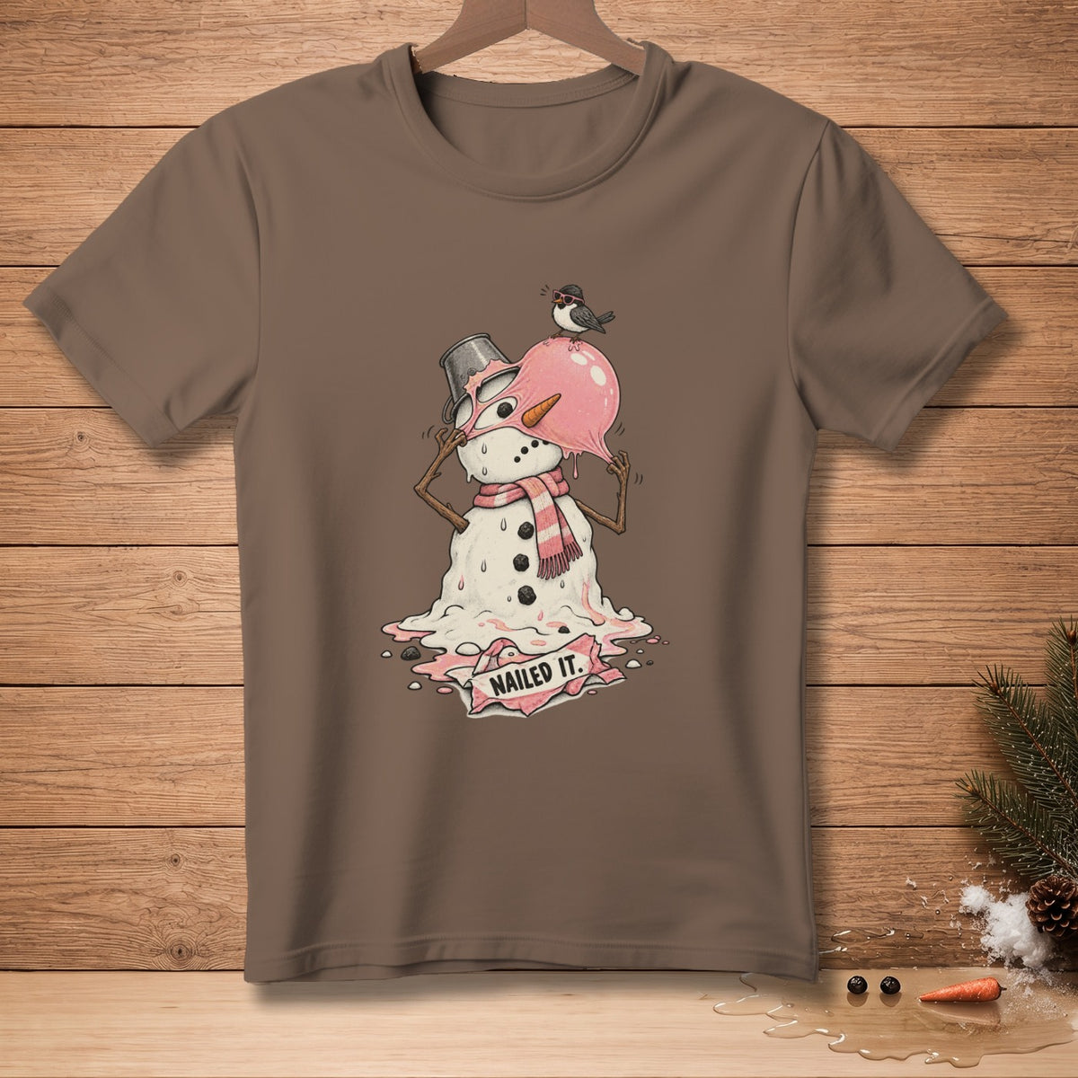 Melting snowman with pink scarf and bucket hat, bird on head, "NAILED IT."