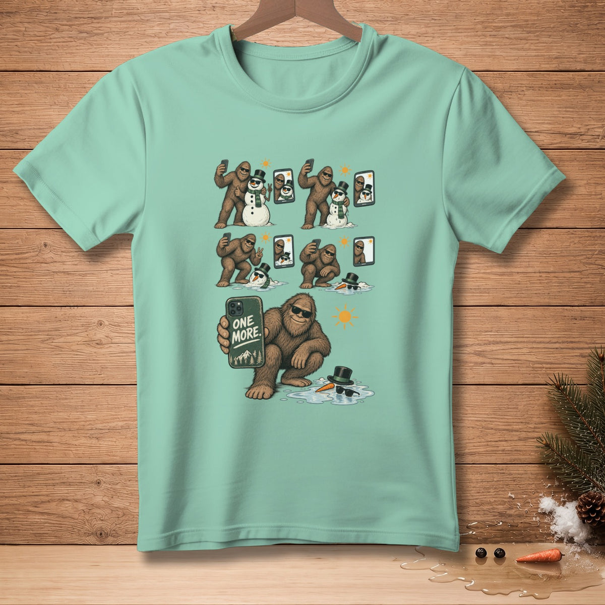 Bigfoot taking selfies with snowmen, one holding a phone that says "ONE MORE."
