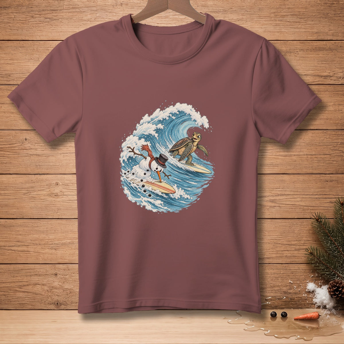 T-shirt with a cartoon snowman and turtle surfing on a wave.