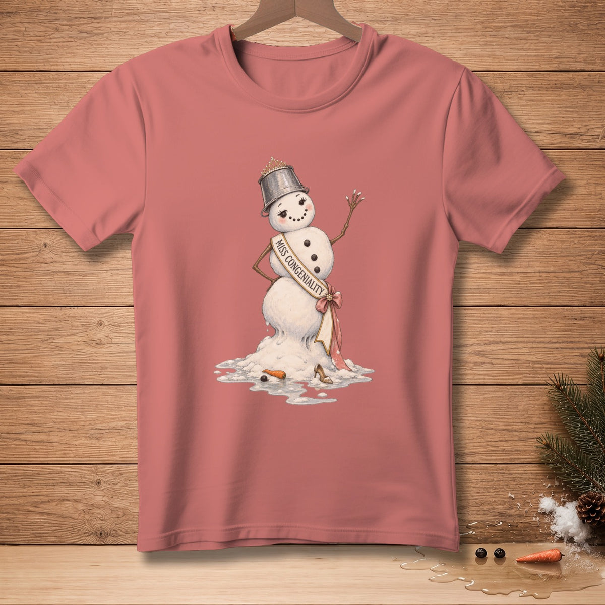 Melting snowman with tiara and "Miss Congeniality" sash on a pink t-shirt.