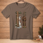 Snowman peeking from tree next to Bigfoot holding a small tree.