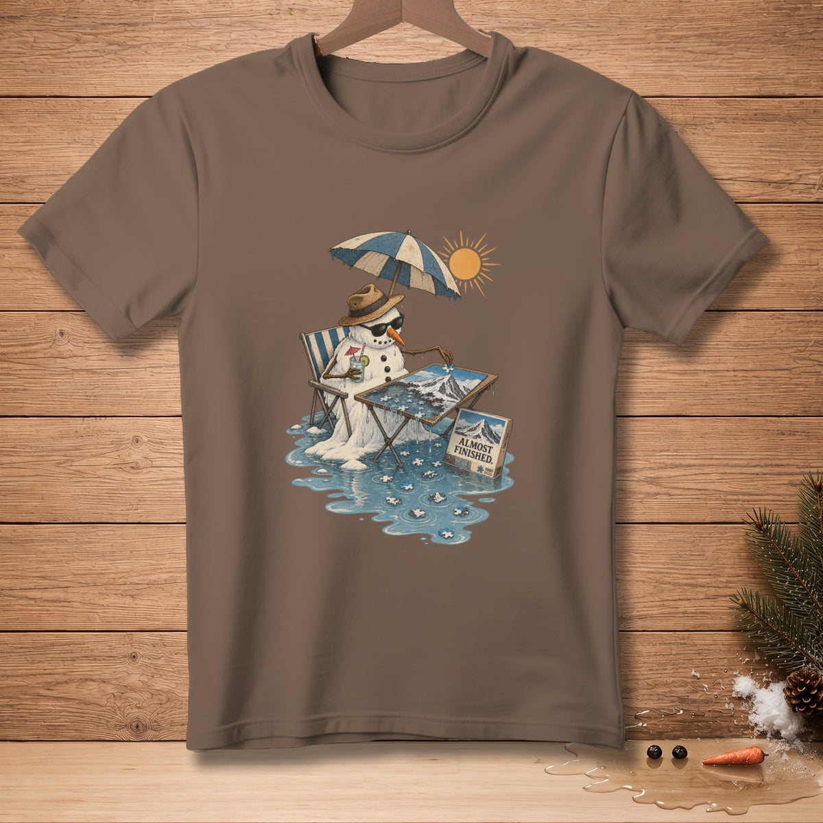 Snowman in sunglasses and hat with umbrella, melting while doing a puzzle that says "ALMOST FINISHED."