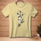 Light yellow t-shirt with a snowman zip-lining upside down.