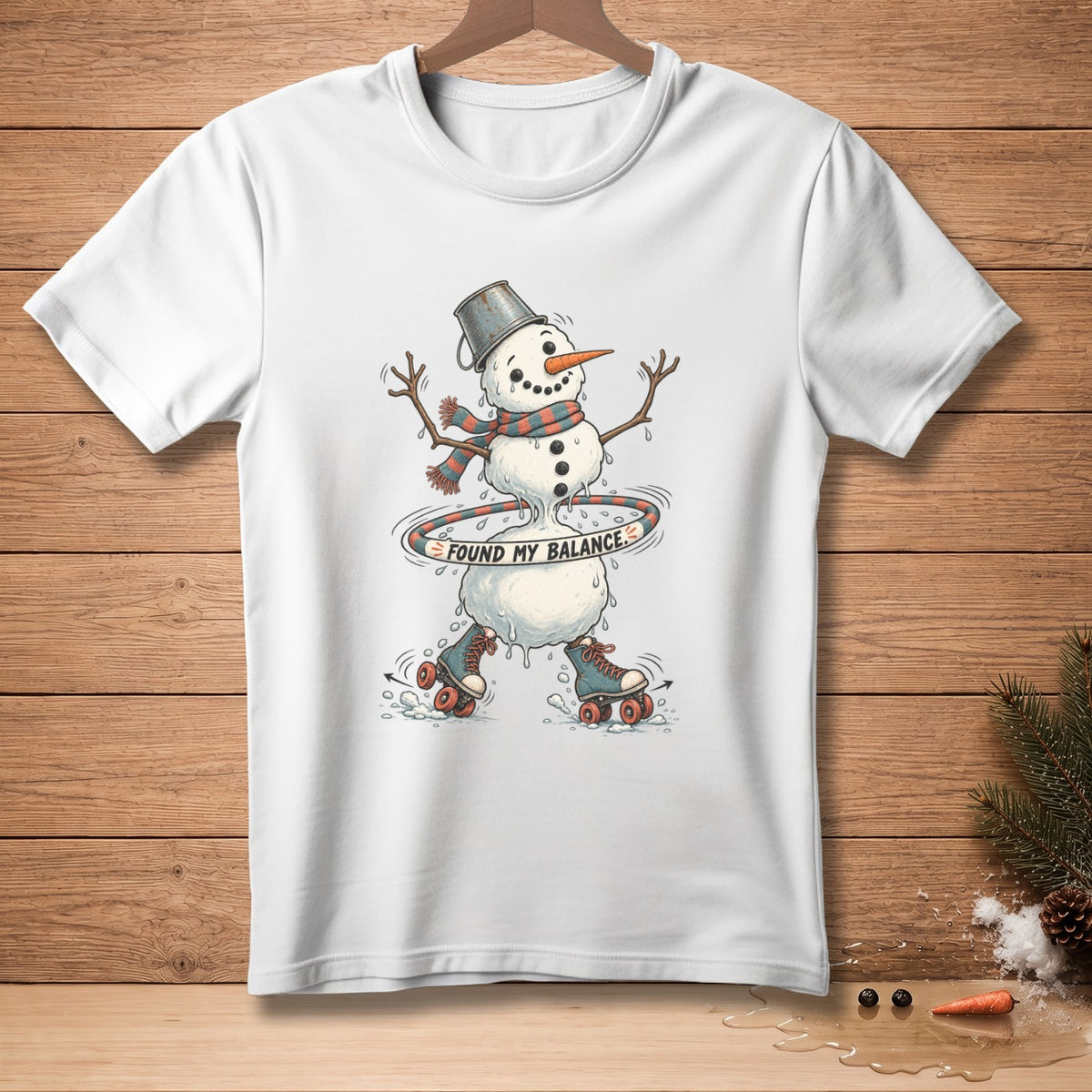 White t-shirt with a melting snowman on roller skates hula hooping, text "FOUND MY BALANCE".