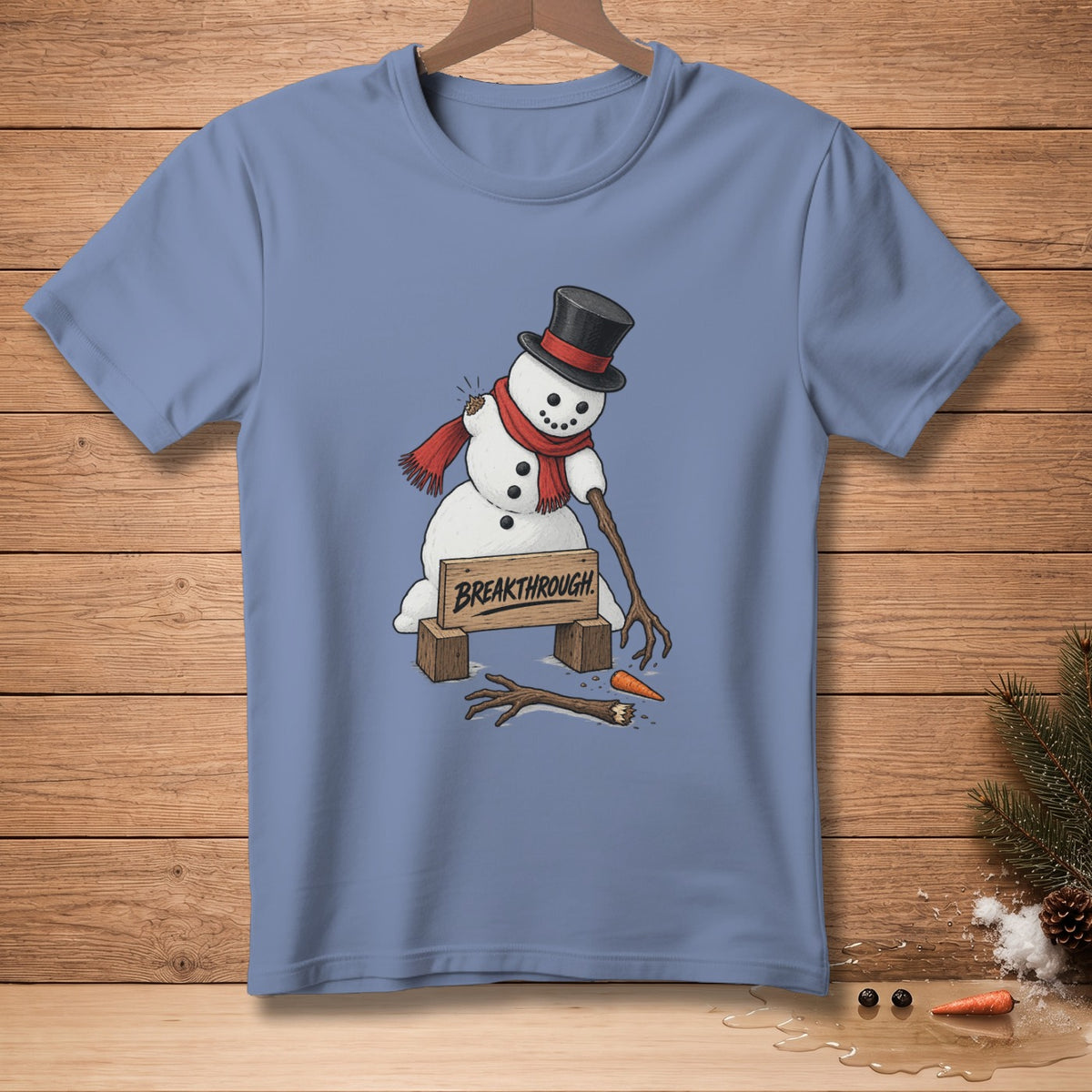 T-shirt with a humorous drawing of a snowman breaking through a sign that says "BREAKTHROUGH".