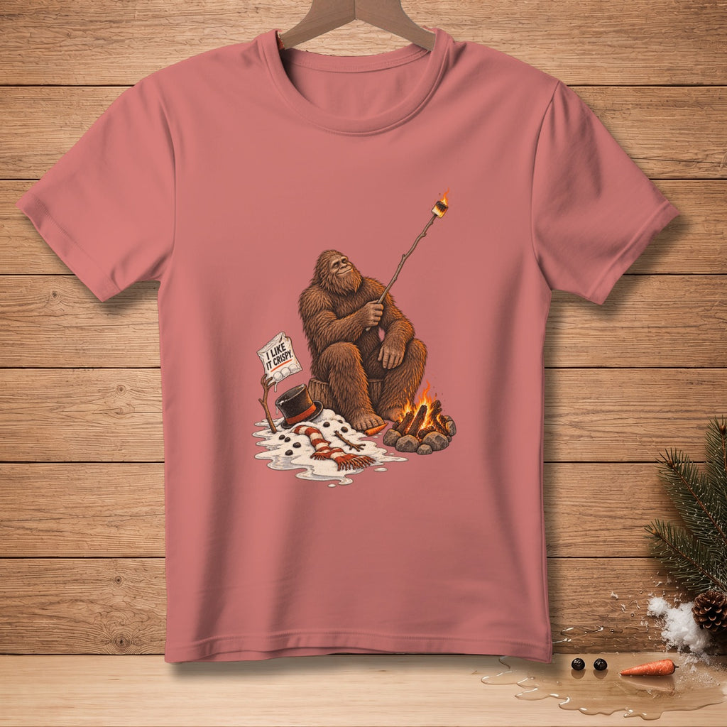 Bigfoot roasting a marshmallow over a campfire with a sign saying "I like it crispy."