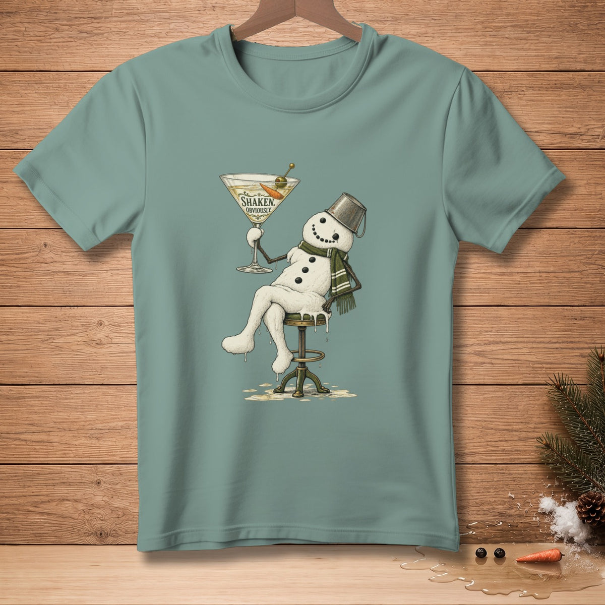 Snowman sitting on stool holding martini glass with text "Shaken Obviously".