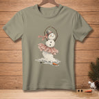 Snowman in a tutu and hat with "GRACEFUL" ribbon, melting on a shirt.