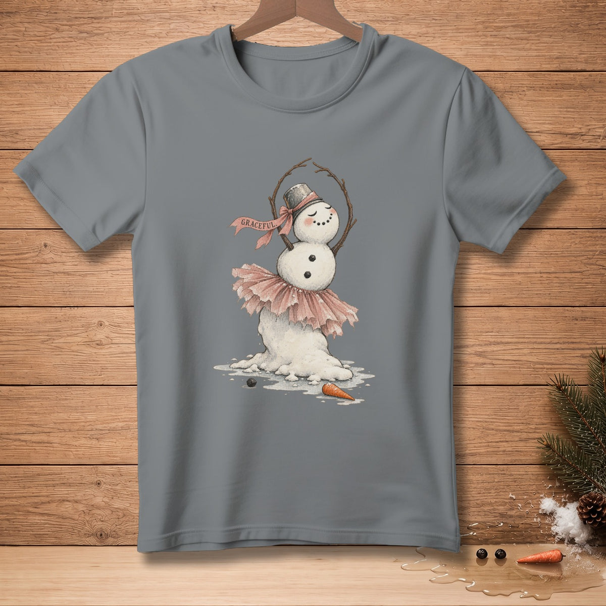 A melting snowman ballet dancer wears a pink tutu and a hat with the word "Graceful."