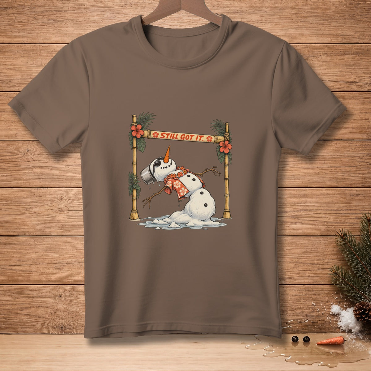 Brown t-shirt with a melting snowman graphic that says "STILL GOT IT."
