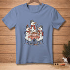 Three snowmen with black hats and red scarves eat spaghetti at a table.