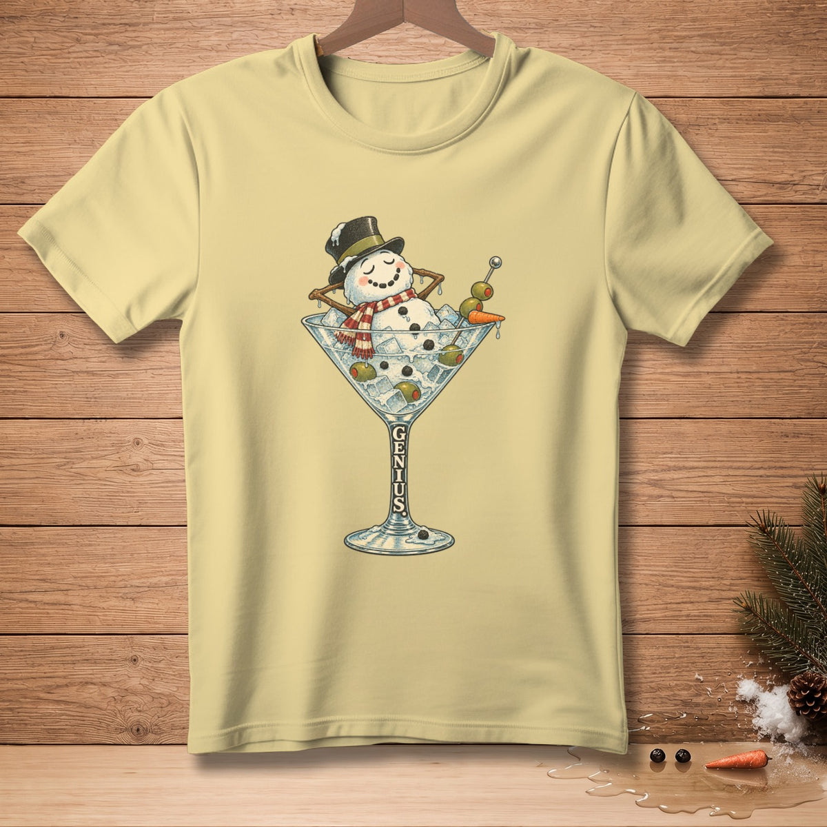 Yellow t-shirt with a snowman relaxing in a martini glass, text "GENIUS" on the glass.