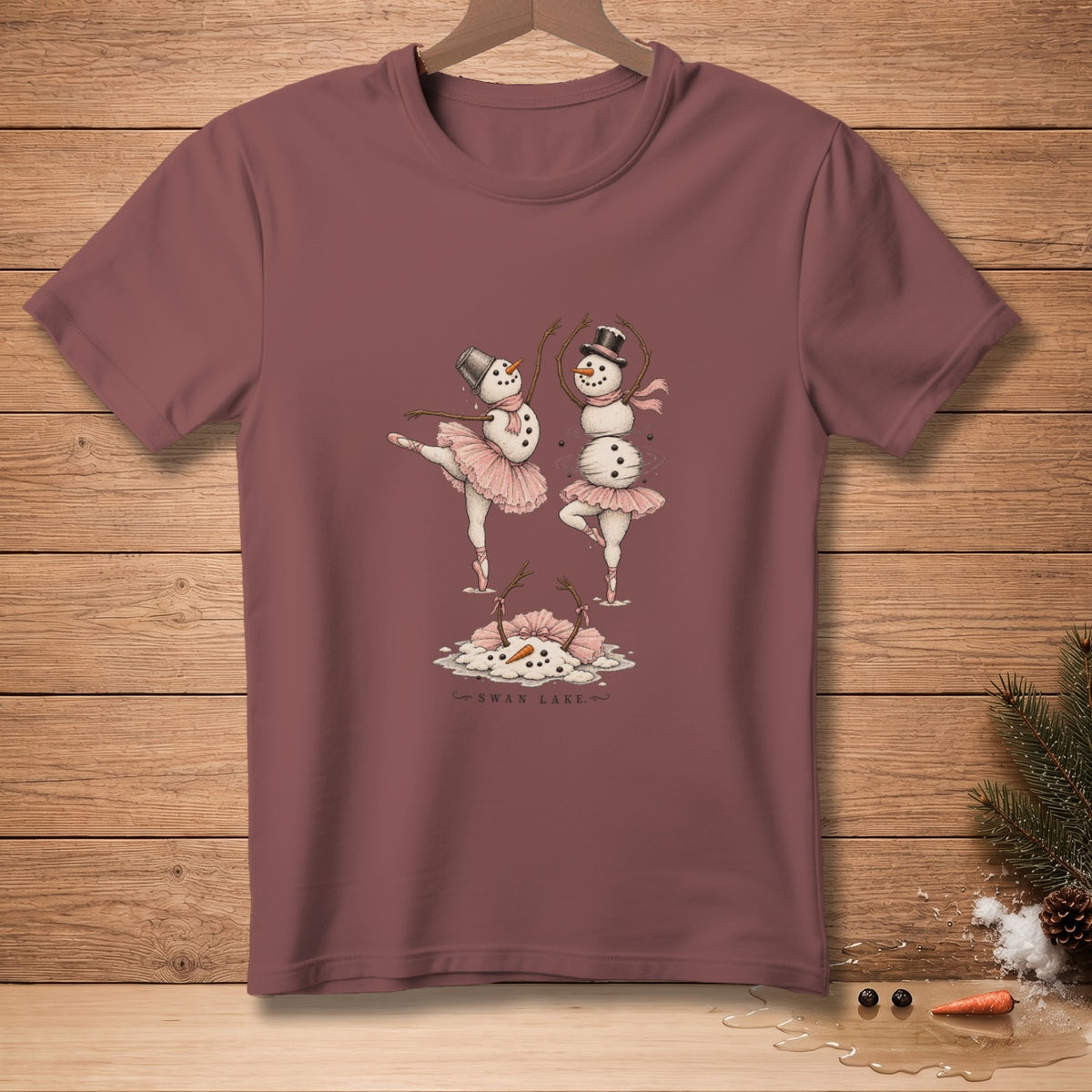 Two snowmen in ballet tutus and pointe shoes dance on a puddle labeled "Swan Lake".
