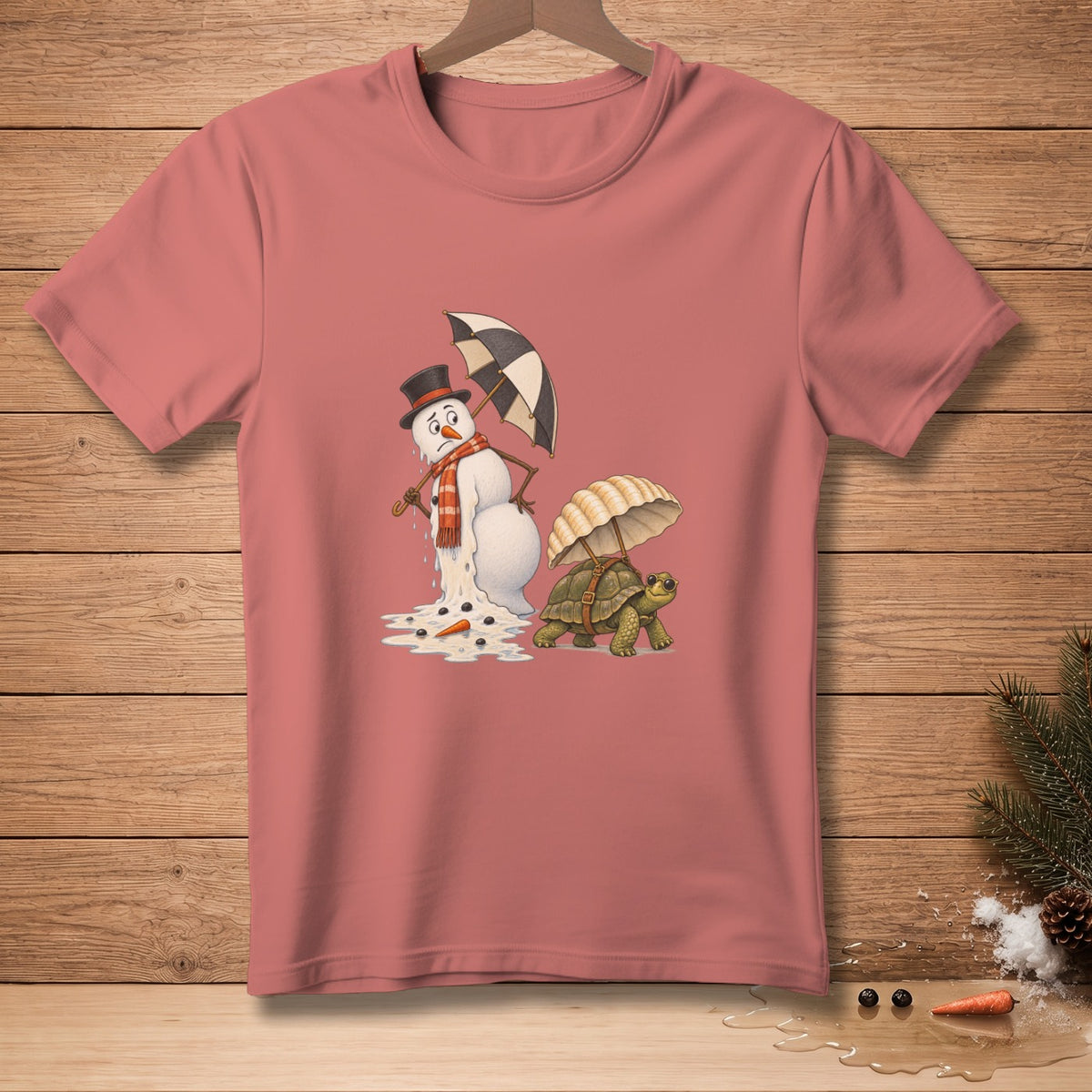Dying snowman with umbrella beside turtle carrying umbrella on dusty rose t-shirt.