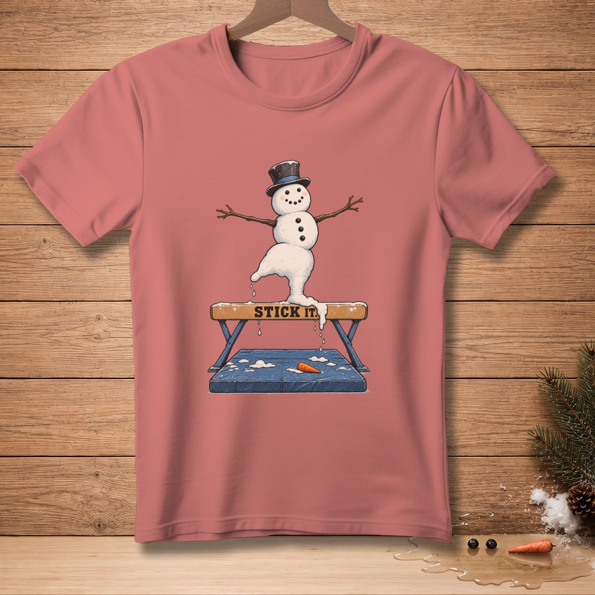 Snowman in a top hat and twig arms balancing on a vaulting horse with "STICK IT" text.