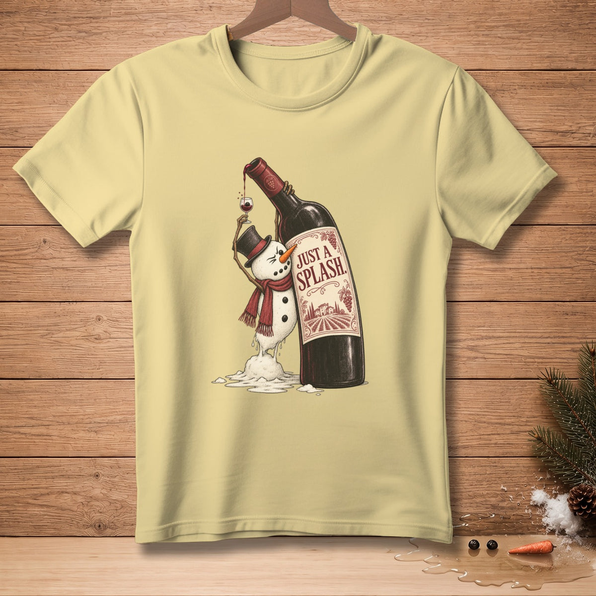 Yellow t-shirt graphic of a melting snowman holding wine with text "JUST A SPLASH."