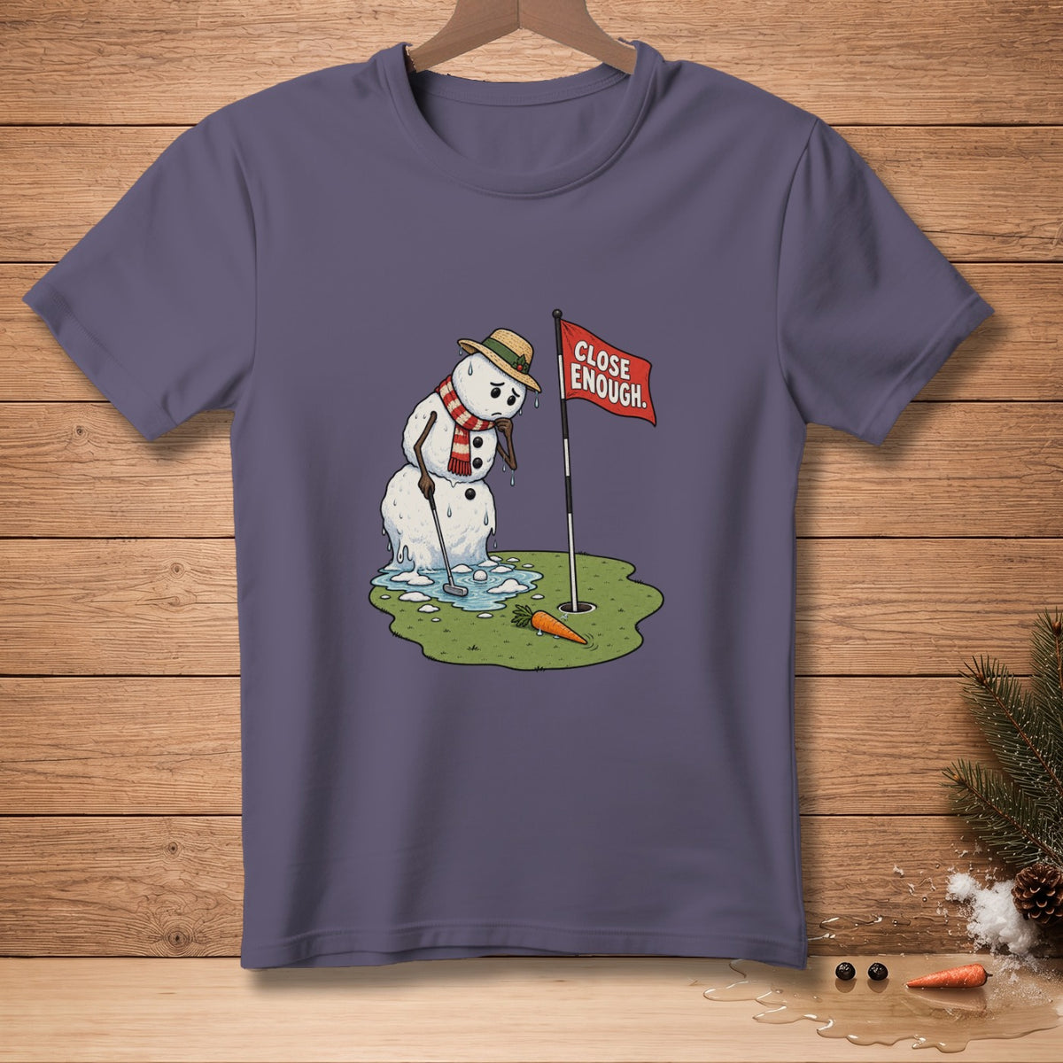 Melting snowman golfer with straw hat, scarf, and golf club, near a flag reading "CLOSE ENOUGH".