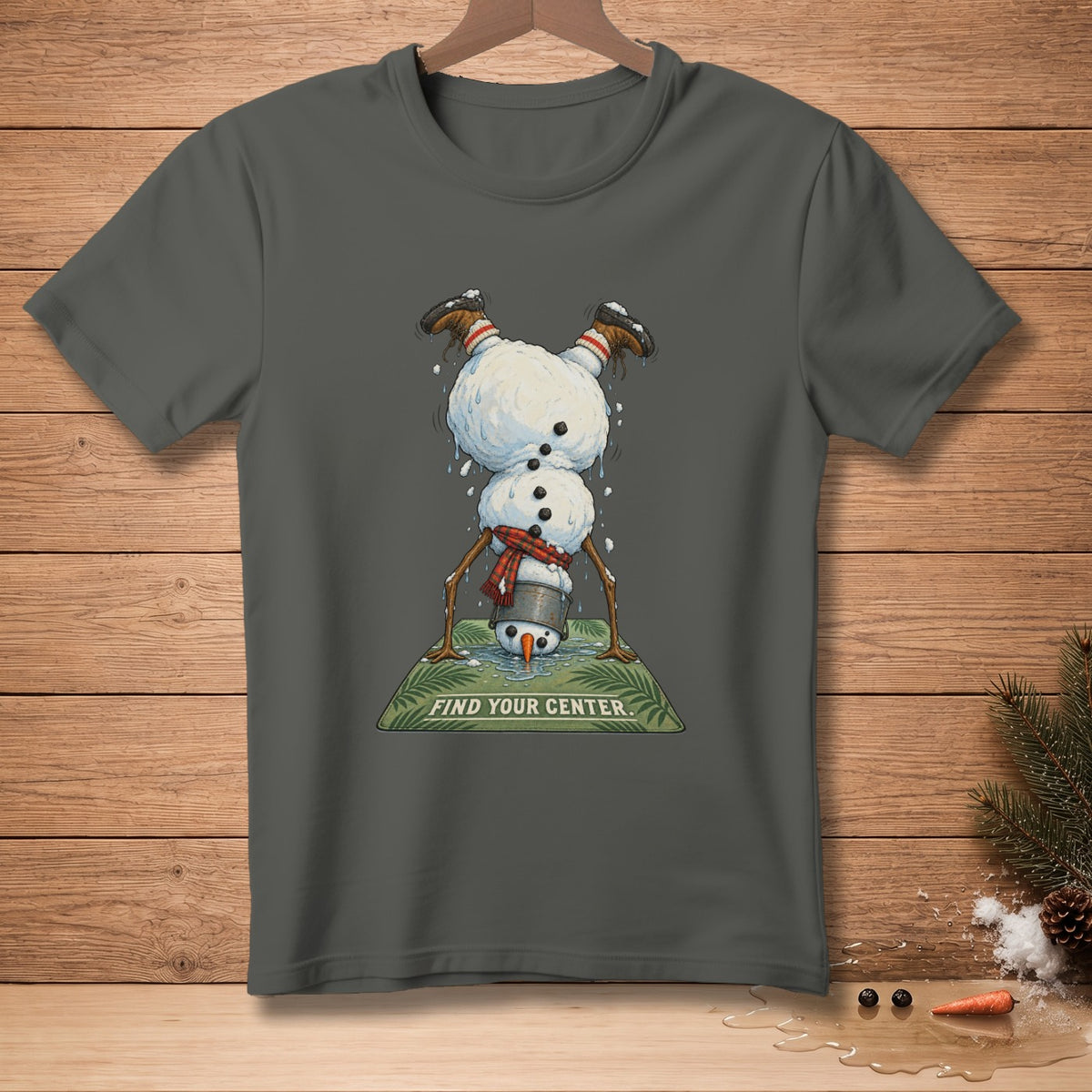 Dark grey t-shirt with snowman doing a handstand on a mat that says "FIND YOUR CENTER."