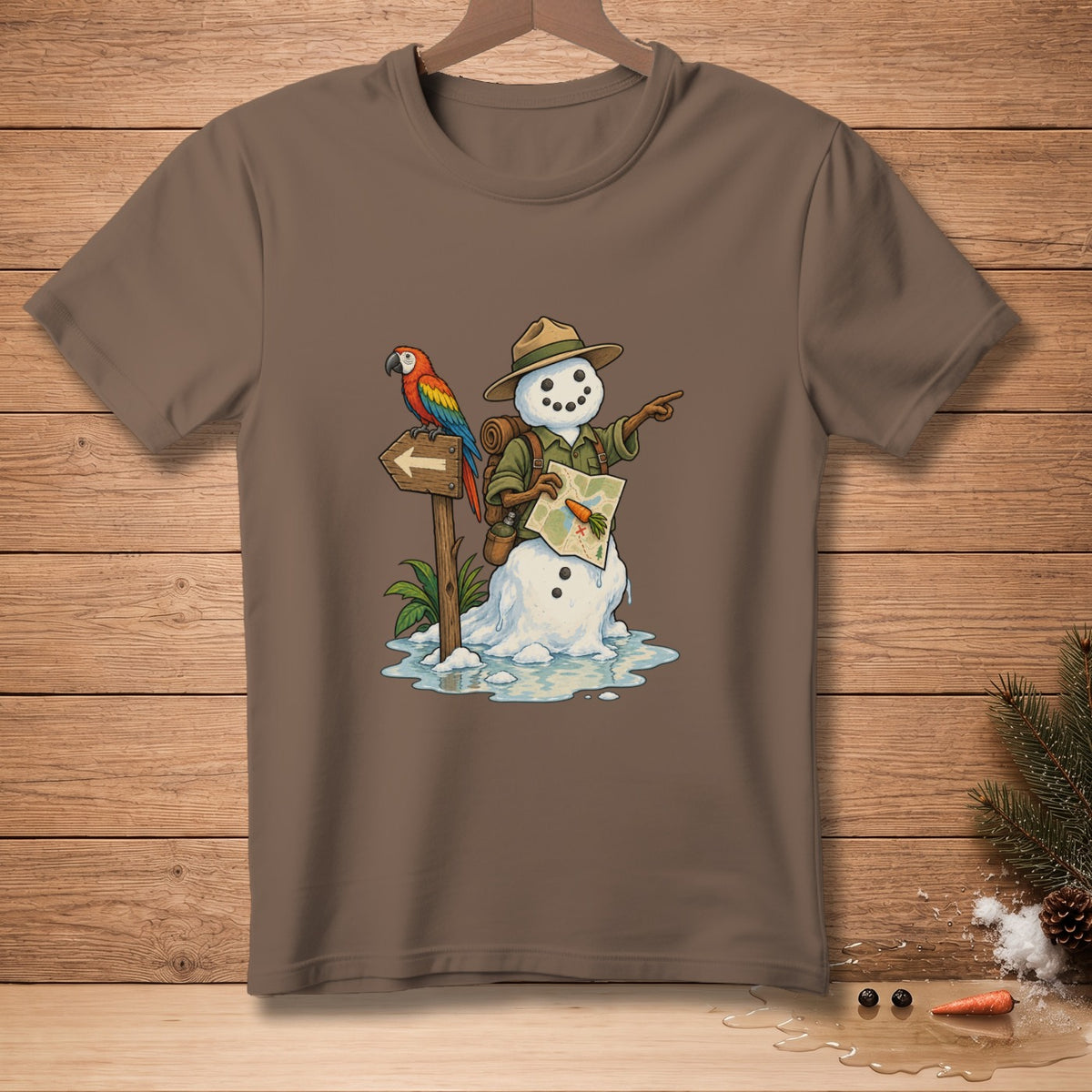 Snowman adventurer with parrot and map on a brown t-shirt.