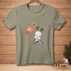 A flamingo stands next to a snowman doing a handstand, with his hat fallen off.
